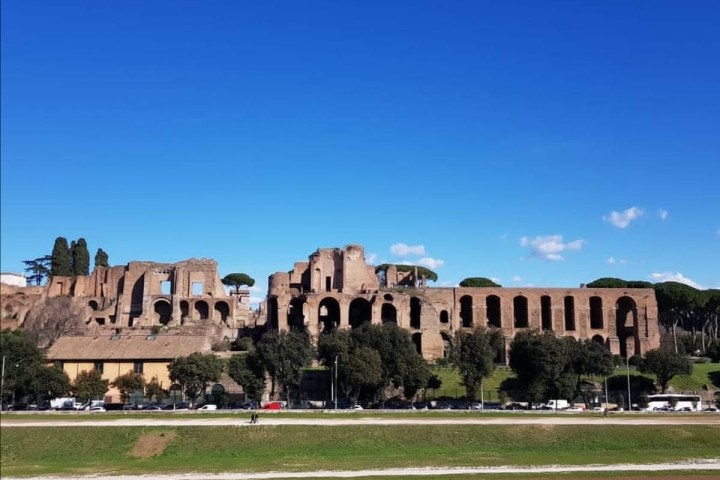 a large building with Circus Maximus in the background